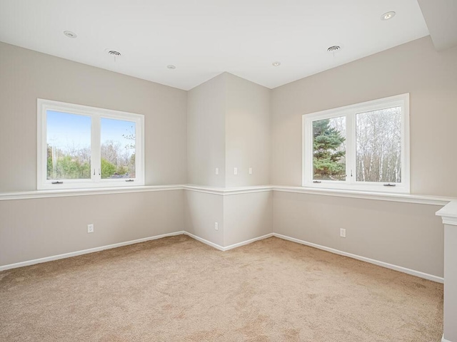 empty room with visible vents, baseboards, and carpet floors
