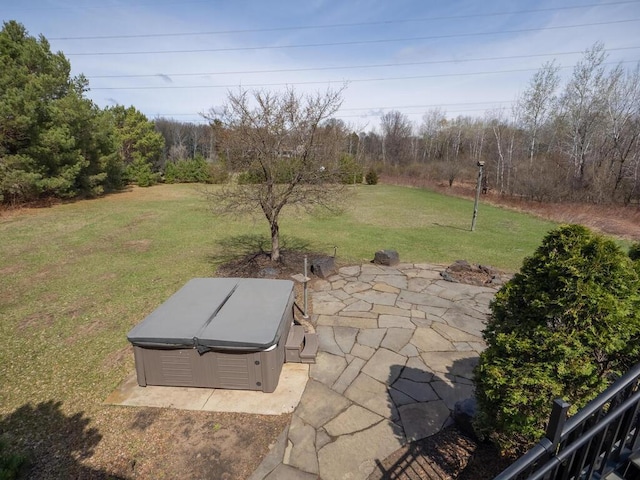 entry to storm shelter featuring a lawn, a jacuzzi, and a patio area