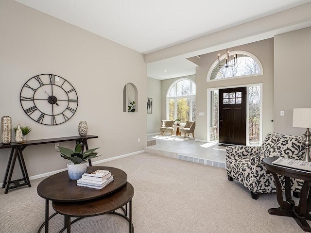 foyer entrance with baseboards and carpet floors