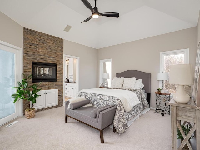 bedroom with visible vents, light carpet, ceiling fan, and ensuite bathroom
