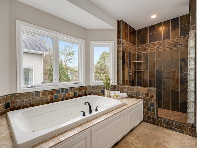 full bathroom featuring recessed lighting, a walk in shower, and a bath