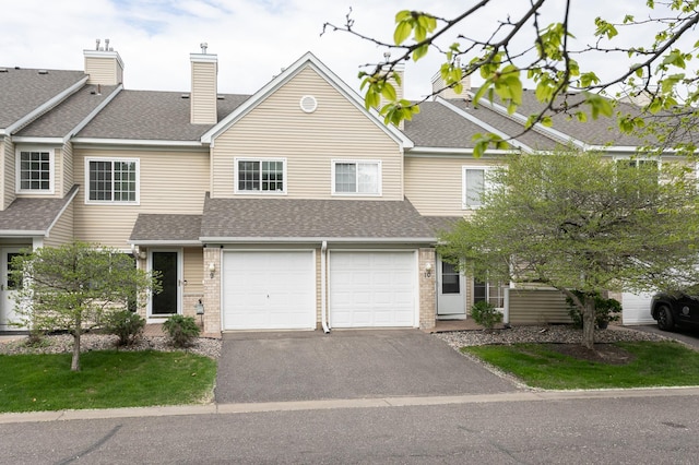 2225 Ranchview Ln N Unit 9, Plymouth, MN 55447 - townhome / multi-family property with driveway, roof with shingles, a garage, and brick siding