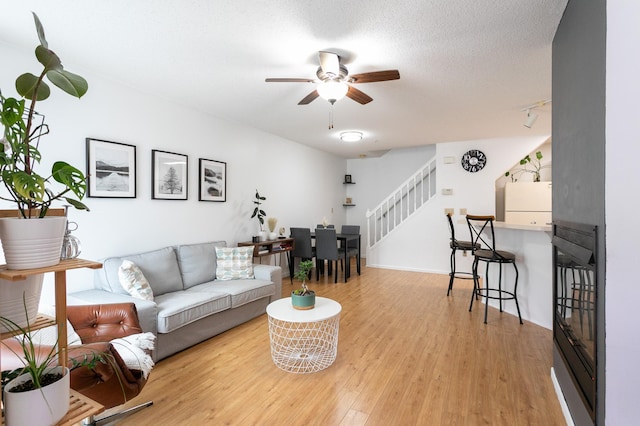 2225 Ranchview Ln N Unit 9, Plymouth, MN 55447 - living room featuring stairway, ceiling fan, and light wood finished floors