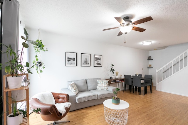 2225 Ranchview Ln N Unit 9, Plymouth, MN 55447 - living room with a ceiling fan, light wood-style floors, stairway, and a textured ceiling
