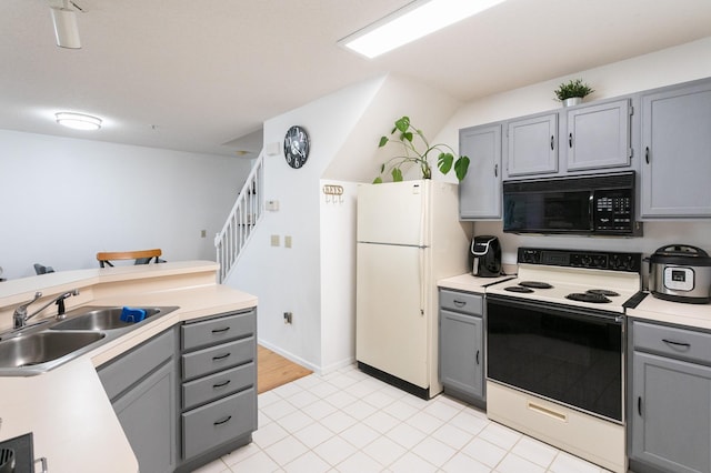 2225 Ranchview Ln N Unit 9, Plymouth, MN 55447 - kitchen with black microwave, range with electric cooktop, gray cabinetry, freestanding refrigerator, and light countertops