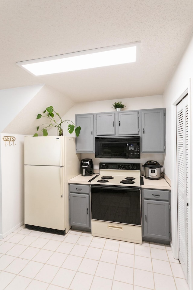 2225 Ranchview Ln N Unit 9, Plymouth, MN 55447 - kitchen featuring black microwave, electric range oven, gray cabinetry, and freestanding refrigerator