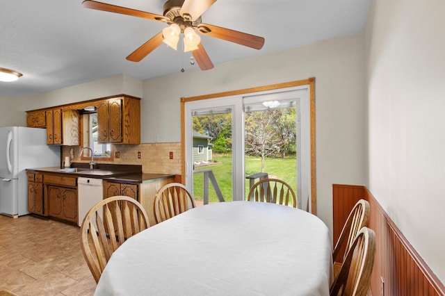 7830 Country Ln, Lino Lakes, MN 55014 - dining space featuring ceiling fan and a wainscoted wall