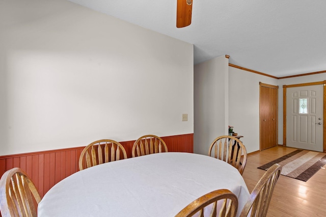 7830 Country Ln, Lino Lakes, MN 55014 - dining space featuring a wainscoted wall, light wood-style floors, and wood walls