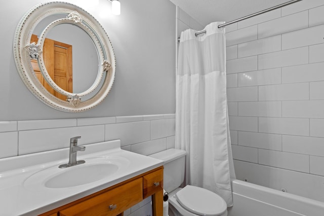 7830 Country Ln, Lino Lakes, MN 55014 - bathroom with toilet, vanity, shower / bathtub combination with curtain, tile walls, and wainscoting