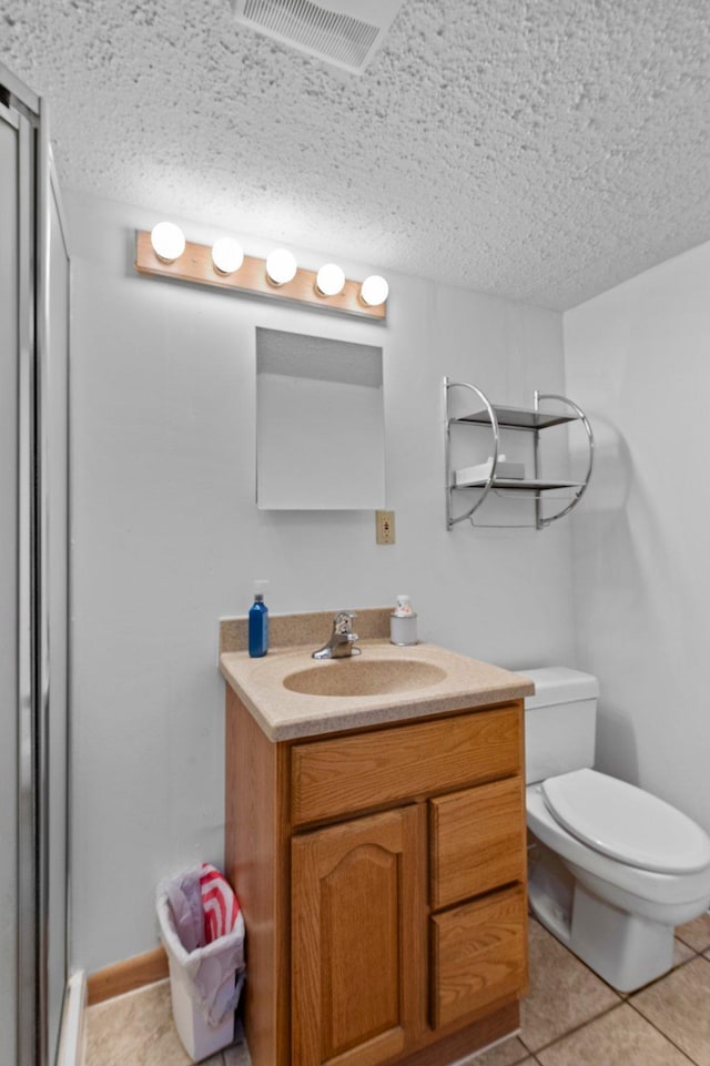 7830 Country Ln, Lino Lakes, MN 55014 - full bath with vanity, a textured ceiling, tile patterned flooring, toilet, and an enclosed shower
