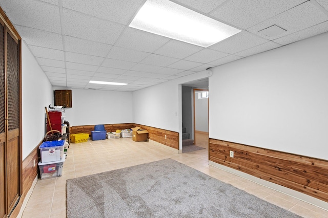 7830 Country Ln, Lino Lakes, MN 55014 - recreation room featuring tile patterned flooring, a drop ceiling, wooden walls, and wainscoting