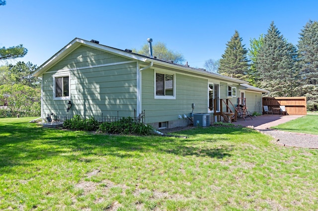 7830 Country Ln, Lino Lakes, MN 55014 - view of side of home featuring a patio area, a lawn, and central AC unit