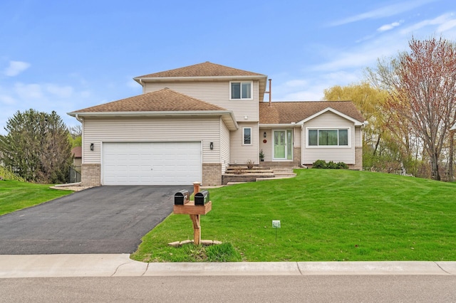view of front facade featuring an attached garage, brick siding, a front yard, and aphalt driveway