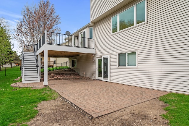 back of property featuring a yard, a patio, a deck, and stairs