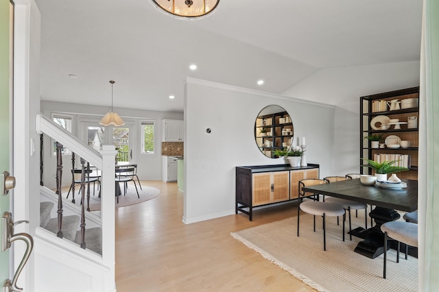 dining space with lofted ceiling, light wood-type flooring, recessed lighting, stairway, and baseboards