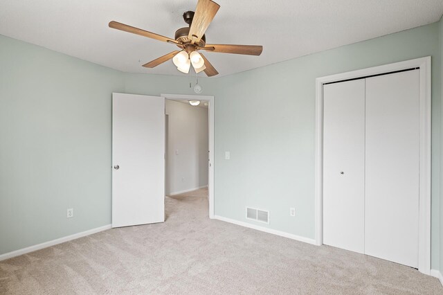 unfurnished bedroom featuring carpet flooring, a closet, visible vents, and baseboards