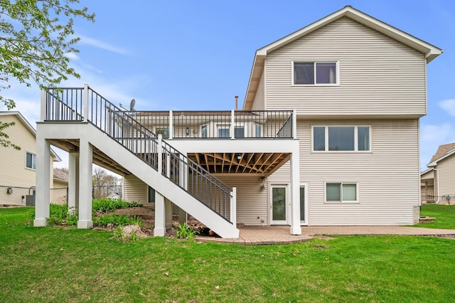 rear view of house with cooling unit, a yard, a wooden deck, and stairs