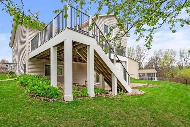 rear view of house with stairway, fence, a yard, and a deck