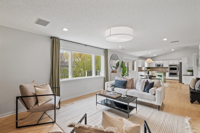 living room featuring baseboards, light wood-style floors, recessed lighting, and vaulted ceiling