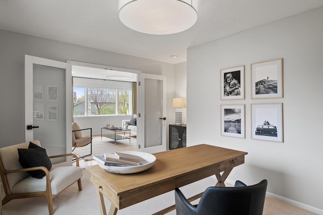 office with light colored carpet and baseboards