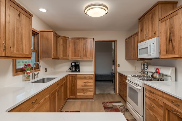 829 Church St, Saint Peter, MN 56082 - kitchen featuring white appliances, light wood-style floors, and brown cabinetry