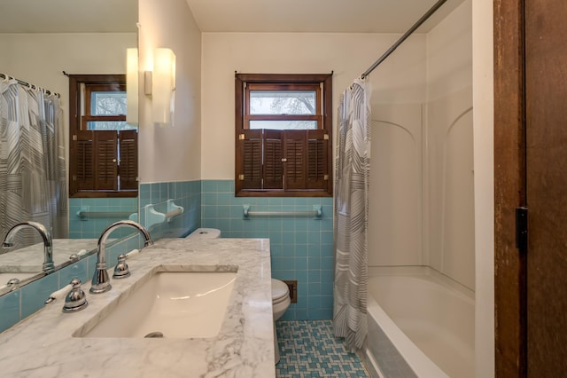 829 Church St, Saint Peter, MN 56082 - full bath with vanity, tile walls, shower / bathtub combination with curtain, wainscoting, and tile patterned floors