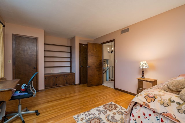 829 Church St, Saint Peter, MN 56082 - bedroom with wood finished floors and a chandelier