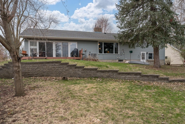 829 Church St, Saint Peter, MN 56082 - rear view of property featuring a chimney, a lawn, and a sunroom