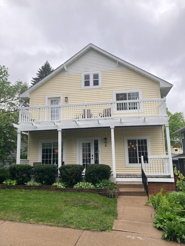 8 Queen Ave S, Minneapolis, MN 55405 - view of front of house featuring covered porch, a balcony, and a front yard