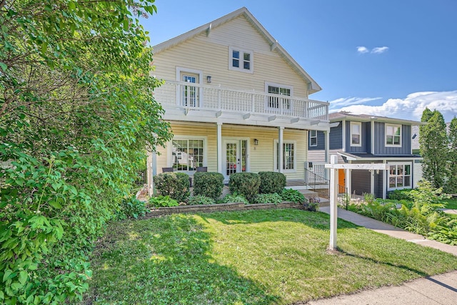 8 Queen Ave S, Minneapolis, MN 55405 - traditional-style home featuring a balcony, a front lawn, and covered porch