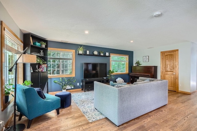 8 Queen Ave S, Minneapolis, MN 55405 - living room with light wood finished floors, a textured ceiling, baseboards, plenty of natural light, and recessed lighting