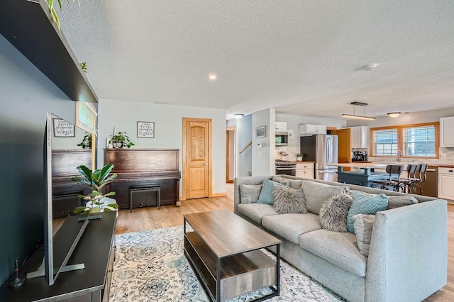 8 Queen Ave S, Minneapolis, MN 55405 - living area with light wood-type flooring and a textured ceiling