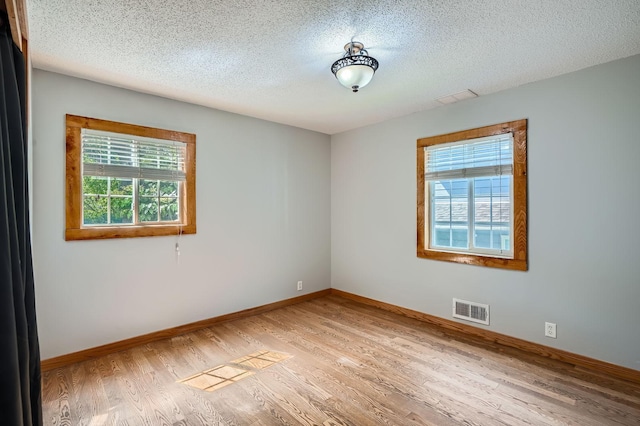 8 Queen Ave S, Minneapolis, MN 55405 - empty room with plenty of natural light, baseboards, and a textured ceiling