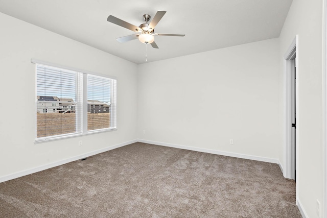 10203 Twin Lakes Pkwy NW, Elk River, MN 55330 - carpeted spare room with baseboards and ceiling fan