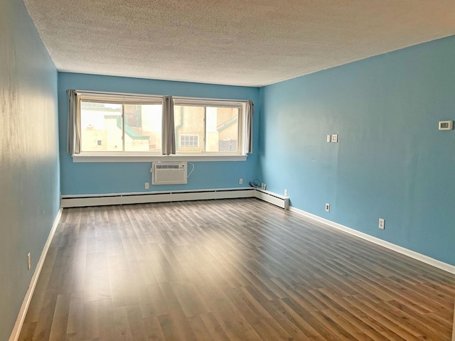empty room with wood finished floors, a textured ceiling, a wall mounted AC, baseboards, and baseboard heating