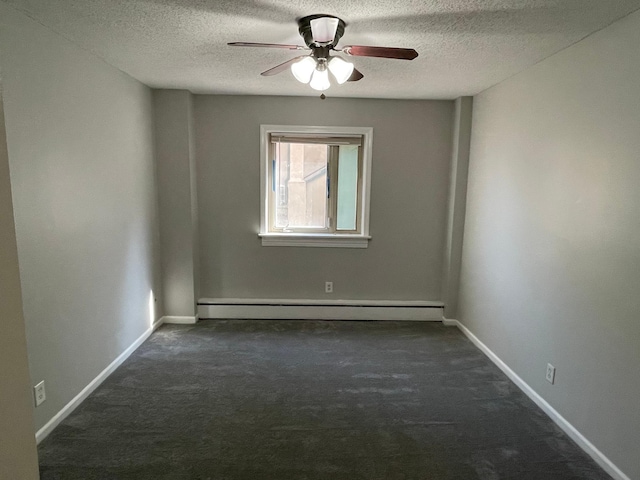 unfurnished room with a baseboard heating unit, ceiling fan, a textured ceiling, dark colored carpet, and baseboards