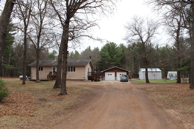 14879 Benson Rd, Grantsburg, WI 54840 - exterior space featuring an outdoor structure, dirt driveway, and a garage