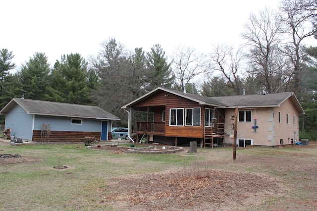 14879 Benson Rd, Grantsburg, WI 54840 - back of property with a lawn, central AC, and a wooden deck