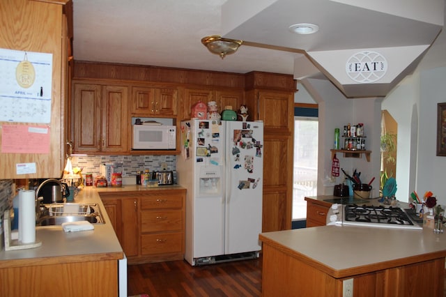 14879 Benson Rd, Grantsburg, WI 54840 - kitchen featuring a sink, light countertops, brown cabinetry, and white appliances