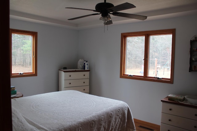 14879 Benson Rd, Grantsburg, WI 54840 - bedroom with ceiling fan, baseboards, visible vents, and wood finished floors