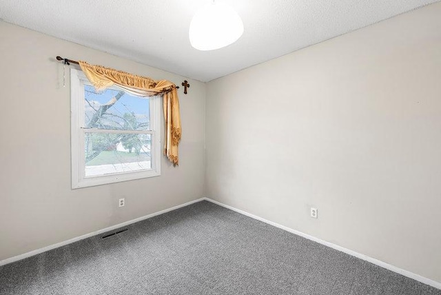 spare room featuring baseboards and carpet