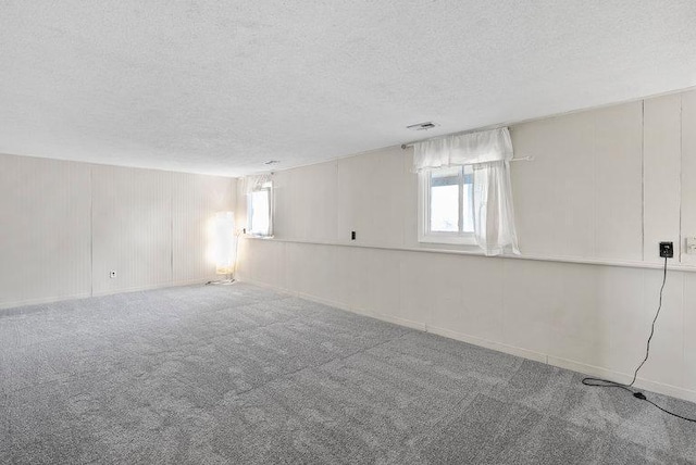 empty room featuring carpet floors and a textured ceiling