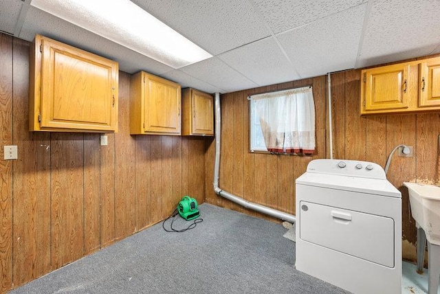 laundry area with washer / clothes dryer, carpet flooring, wood walls, and cabinet space