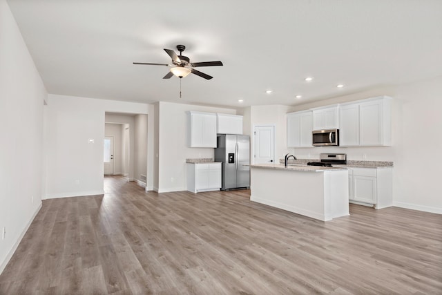 10213 Twin Lakes Pkwy NW, Elk River, MN 55330 - kitchen featuring stainless steel appliances, light wood-type flooring, ceiling fan, recessed lighting, and white cabinetry
