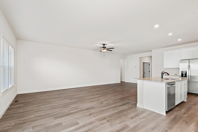 10213 Twin Lakes Pkwy NW, Elk River, MN 55330 - kitchen featuring appliances with stainless steel finishes, healthy amount of natural light, ceiling fan, light wood-style floors, and recessed lighting