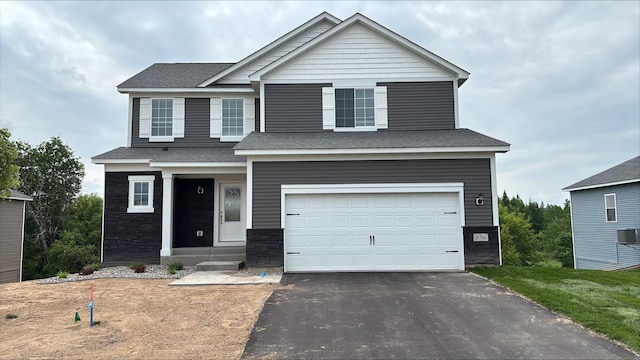 18766 Ivanhoe St NW, Elk River, MN 55330 - view of front facade with an attached garage, asphalt driveway, and roof with shingles