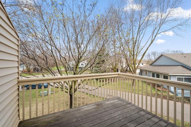 deck featuring a residential view and a yard