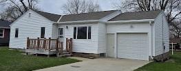 141 Ray Ave, Jackson, MN 56143 - back of property featuring driveway, a yard, and a garage