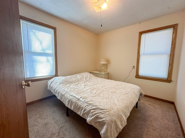 carpeted bedroom featuring baseboards
