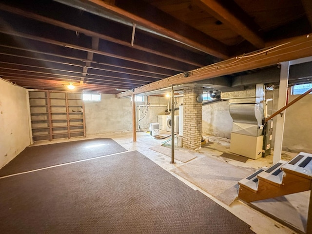 below grade area featuring heating unit and plenty of natural light